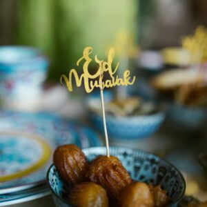 Charming Eid Mubarak scene with traditional sweets in a ceramic bowl, perfect for festive occasions.